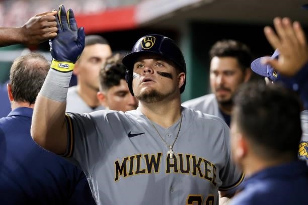 Daniel Vogelbach of the Milwaukee Brewers celebrates with teammates after hitting a home run in the ninth inning against the Cincinnati Reds at Great...