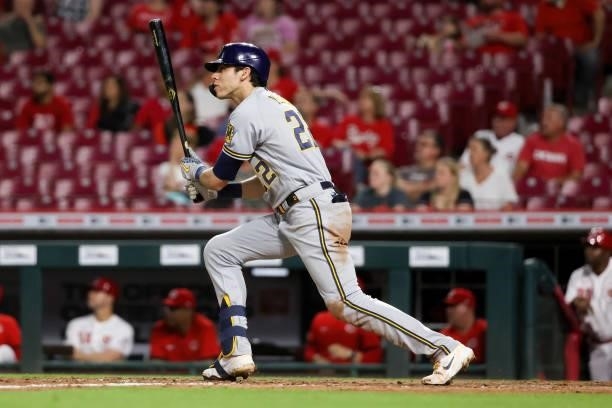 Christian Yelich of the Milwaukee Brewers hits a double in the ninth inning against the Cincinnati Reds at Great American Ball Park on June 09, 2021...