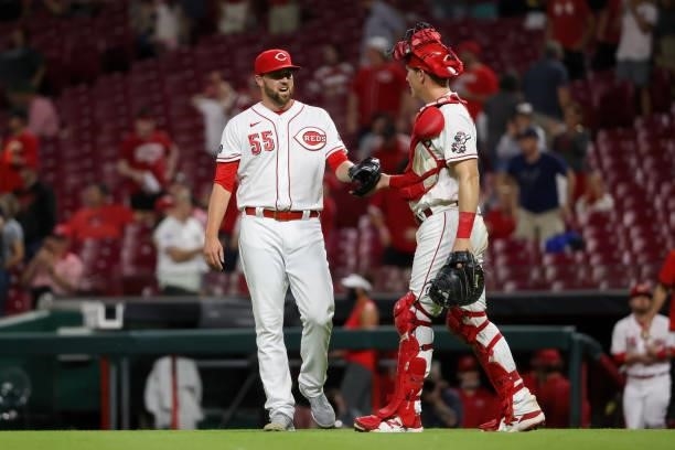 Heath Hembree and Tyler Stephenson of the Cincinnati Reds celebrate after beating the Milwaukee Brewers 7-3 at Great American Ball Park on June 09,...