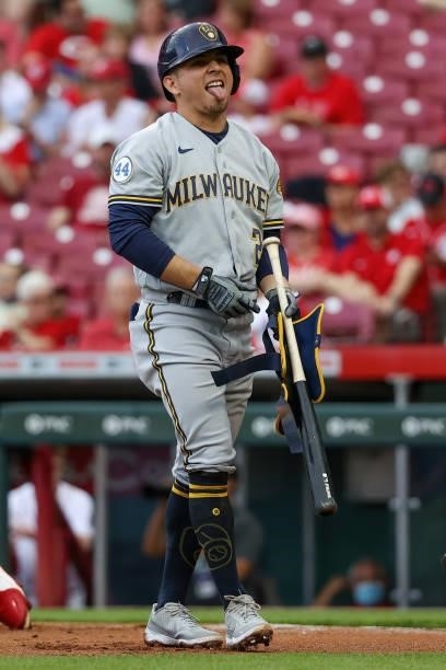 Luis Urias of the Milwaukee Brewers reacts after being hit by a pitch in the first inning against the Cincinnati Reds at Great American Ball Park on...