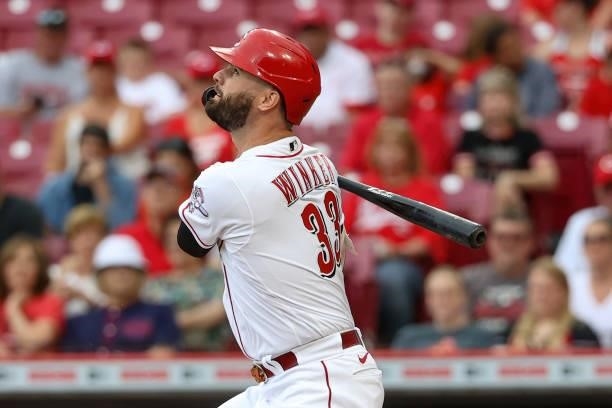 Jesse Winker of the Cincinnati Reds hits a single in the first inning against the Milwaukee Brewers at Great American Ball Park on June 09, 2021 in...