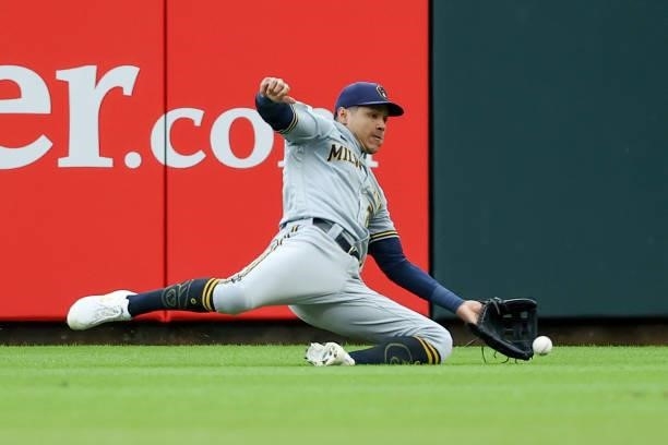 Avisail Garcia of the Milwaukee Brewers slides in an attempt to catch a fly ball in the first inning against the Cincinnati Reds at Great American...