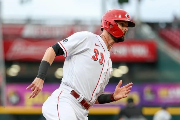 Jesse Winker of the Cincinnati Reds runs to third base in the first inning against the Milwaukee Brewers at Great American Ball Park on June 09, 2021...