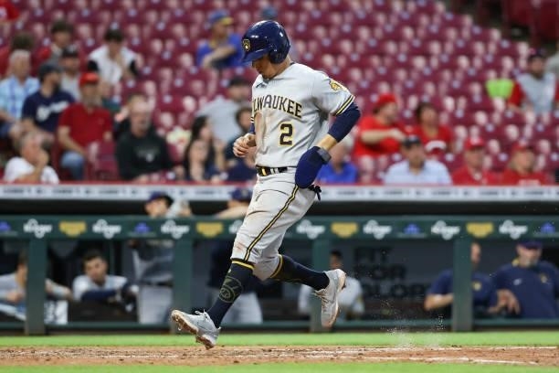 Luis Urias of the Milwaukee Brewers scores a run in the fifth inning against the Cincinnati Reds at Great American Ball Park on June 09, 2021 in...