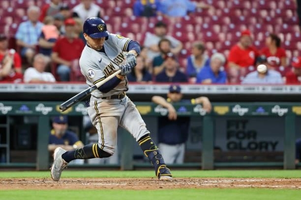 Luis Urias of the Milwaukee Brewers hits a double in the fifth inning against the Cincinnati Reds at Great American Ball Park on June 09, 2021 in...