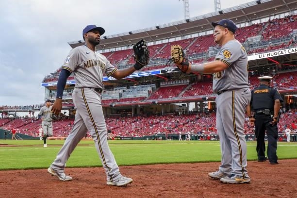 Jackie Bradley Jr. #41 and Daniel Vogelbach of the Milwaukee Brewers walk across the field in the third inning against the Cincinnati Reds at Great...