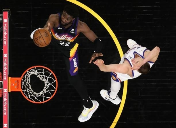 Deandre Ayton of the Phoenix Suns lays up a shot past Nikola Jokic of the Denver Nuggets during the first half in Game Two of the Western Conference...