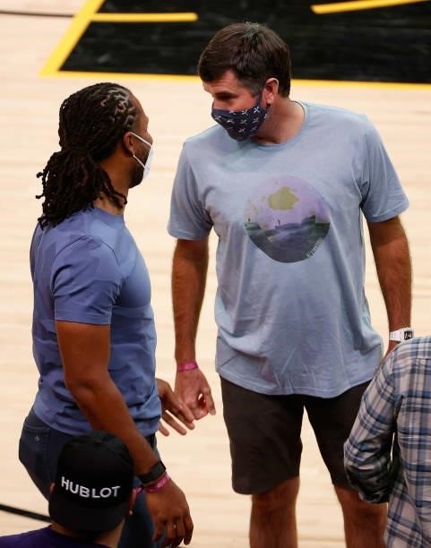 Athlete Larry Fitzgerald talks with professional golfer Bubba Watson following Game Two of the Western Conference second-round playoff series at...