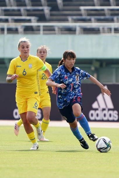 Emi Nakajima of Japan controls the ball under pressure of Olga Basanska of Ukraine during the women's international friendly match between Japan and...