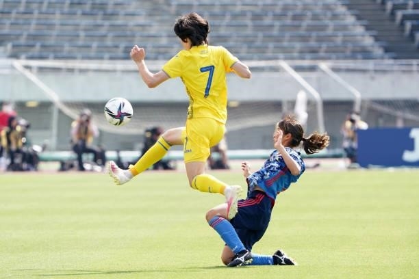 Yana Kalinina of Ukraine is tackled by Emi Nakajima of Japan during the women's international friendly match between Japan and Ukraine at Edion...