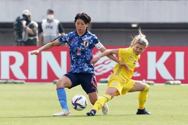 Saki Kumagai of Japan and Ganna Voronina of Ukraine compete for the ball during the women's international friendly match between Japan and Ukraine at...