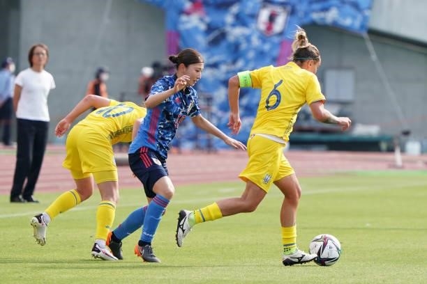 Olga Basanska of Ukraine and Yuzuho Shiokoshi of Japan compete for the ball during the women's international friendly match between Japan and Ukraine...