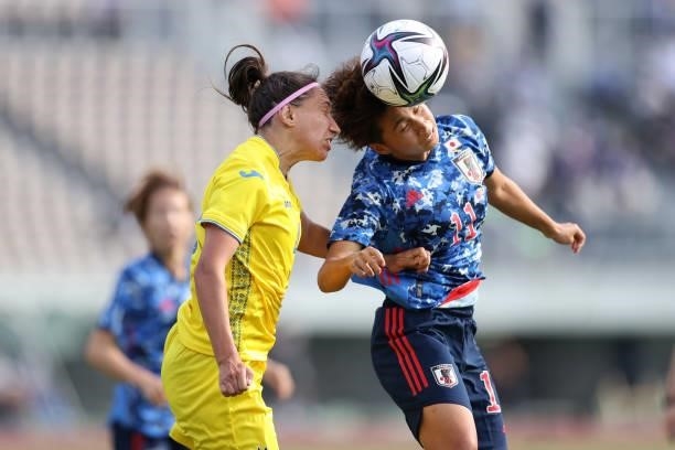 Mina Tanaka of Japan and Anastasiia Filenko of Ukraine compete for the ball during the women's international friendly match between Japan and Ukraine...