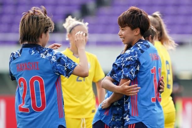 Mina Tanaka of Japan celebrates scoring her side's seventh goal with her team mates Emi Nakajima and Honoka Hayashi during the women's international...
