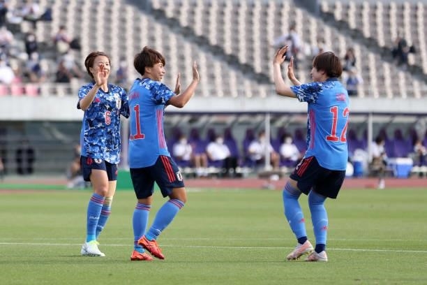 Mina Tanaka of Japan celebrates scoring her side's seventh goal with her team mates Hina Sugita and Jun Endo during the women's international...