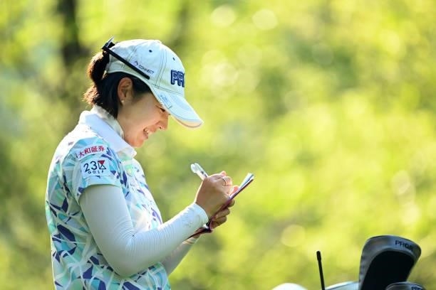 Rie Tsuji of Japan checks her yardage book on the 3rd tee during the first round of the Ai Miyazato Suntory Ladies Open at Rokko Kokusai Golf Club on...