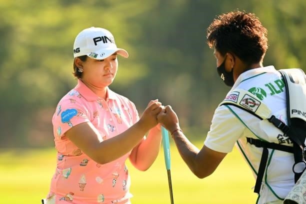 Ai Suzuki of Japan fist bumps with her caddie after the birdie on the 17th green during the first round of the Ai Miyazato Suntory Ladies Open at...