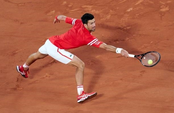 Novak Djokovic of Serbia returns a ball in his Quarter Final match against Matteo Berrettini of Italy during day eleven of the 2021 French Open at...