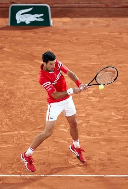 Novak Djokovic of Serbia plays a backhand shot in his Quarter Final match against Matteo Berrettini of Italy during day eleven of the 2021 French...