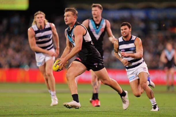 Ollie Wines of the Power kicks the ball during the round 13 AFL match between the Port Adelaide Power and the Geelong Cats at Adelaide Oval on June...