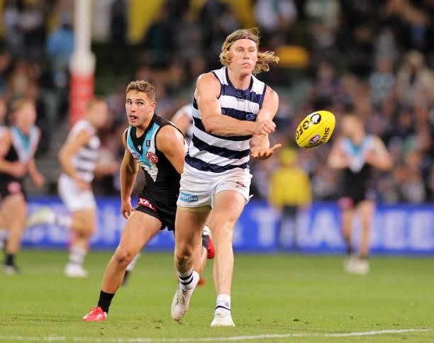 Mark Blicavs of the Cats handballs during the round 13 AFL match between the Port Adelaide Power and the Geelong Cats at Adelaide Oval on June 10,...