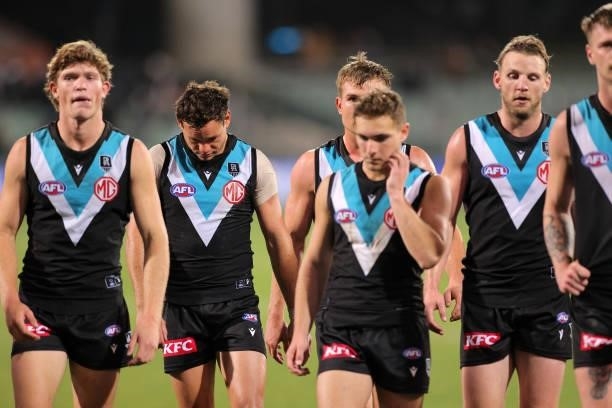 Port Adelaide players walk from the ground looking dejected during the round 13 AFL match between the Port Adelaide Power and the Geelong Cats at...