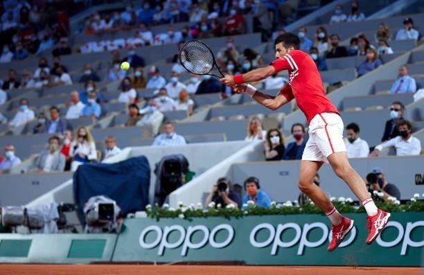 Novak Djokovic of Serbia plays a backhand shot in his Quarter Final match against Matteo Berrettini of Italy during day eleven of the 2021 French...