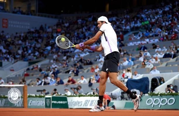 Matteo Berrettini of Italy plays a backhand shot in his Quarter Final match against Novak Djokovic of Serbia during day eleven of the 2021 French...