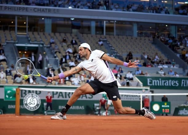 Matteo Berrettini of Italy returns a ball in his Quarter Final match against Novak Djokovic of Serbia during day eleven of the 2021 French Open at...