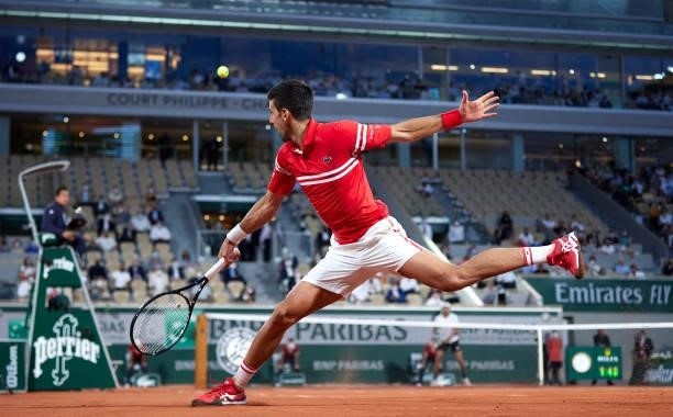 Novak Djokovic of Serbia returns a ball n his Quarter Final match against Matteo Berrettini of Italy during day eleven of the 2021 French Open at...