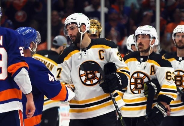 Patrice Bergeron and Brad Marchand of the Boston Bruins shake hands with the New York Islanders after Game Six of the Second Round of the 2021 NHL...