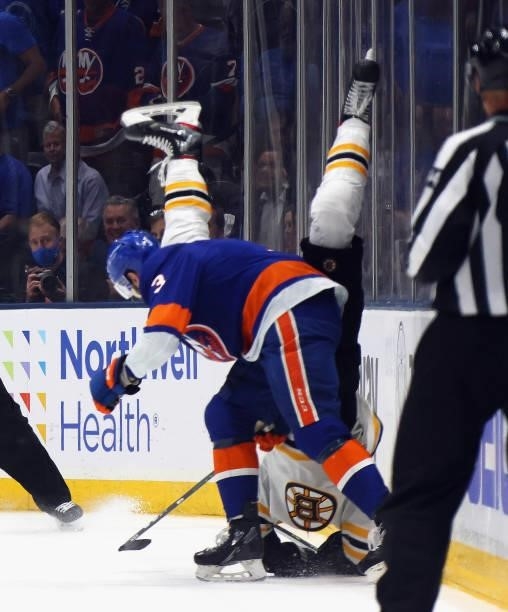 Adam Pelech of the New York Islanders flips Sean Kuraly of the Boston Bruins during the third period in Game Six of the Second Round of the 2021 NHL...