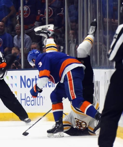 Adam Pelech of the New York Islanders flips Sean Kuraly of the Boston Bruins during the third period in Game Six of the Second Round of the 2021 NHL...