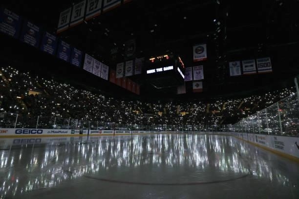 Fans light up the arena with cell phones prior to the game between the New York Islanders and the Boston Bruins in Game Six of the Second Round of...