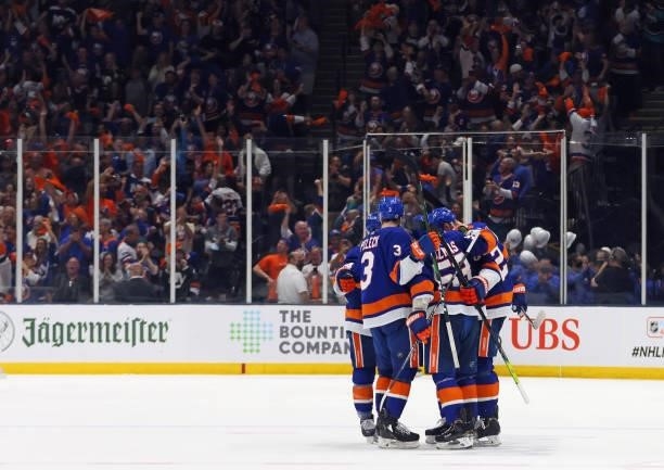 The New York Islanders celebrate an empty net goal by Cal Clutterbuck of the New York Islanders against the Boston Bruins in Game Six of the Second...