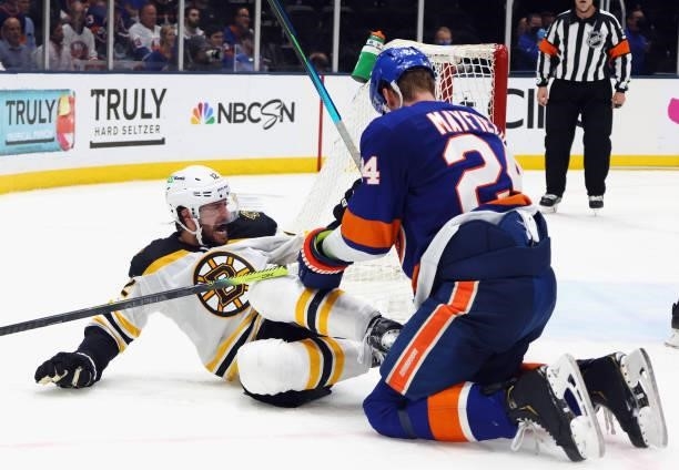 Craig Smith of the Boston Bruins is checked by Scott Mayfield of the New York Islanders in Game Six of the Second Round of the 2021 NHL Stanley Cup...