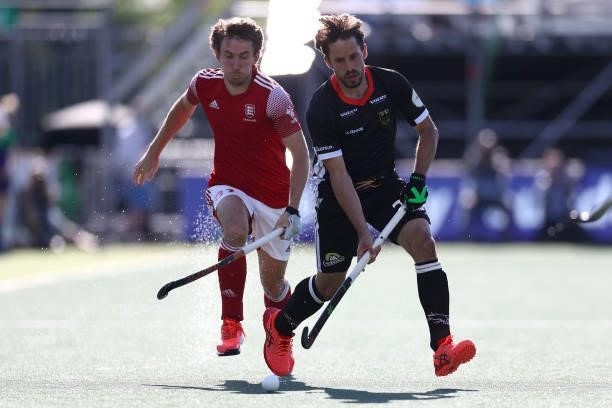 Benedikt Fuerk of Germany gets past the tackle froof Germany Will Calnan of England during the Euro Hockey Championships Mens Semi Final match...