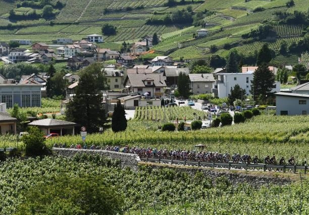 The Peloton passing through Varen during the 84th Tour de Suisse 2021, Stage 5 a 175,2km stage from Gstaad to Leukerbad 1385m / Vineyards / Landscape...