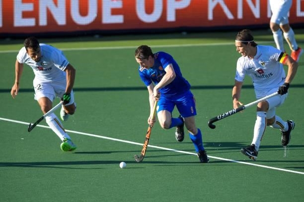 Seve van Ass of the Netherlands battles for possession with Felix Denayer of Belgium and Thomas Briels of Belgium during the Euro Hockey...
