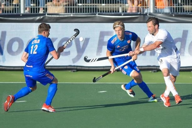 Sebastien Dockier of Belgium battles for possession with Sander de Wijn of the Netherlands and Justen Blok of the Netherlands during the Euro Hockey...