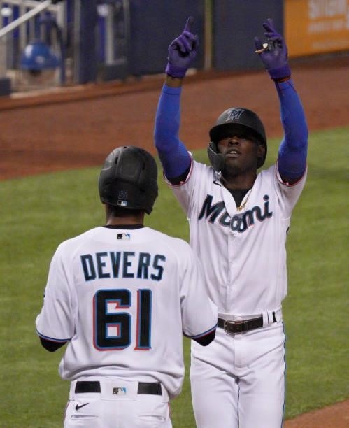 Jazz Chisholm Jr. #2 of the Miami Marlins celebrates with José Devers at home plate after hitting a three-run home run in the second inning against...