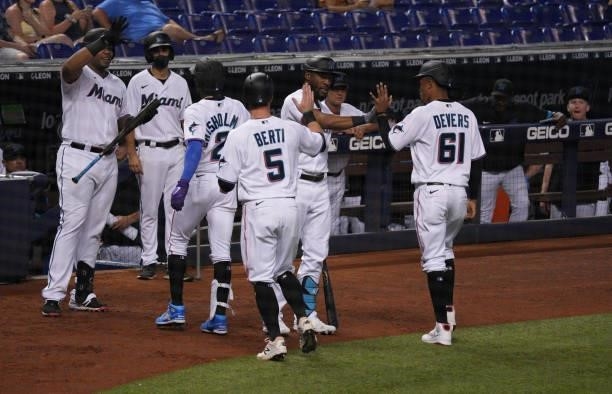 The Miami Marlins celebrate after Jazz Chisholm Jr. #2 hit a three-run home run in the second inning against the Colorado Rockies at loanDepot park...