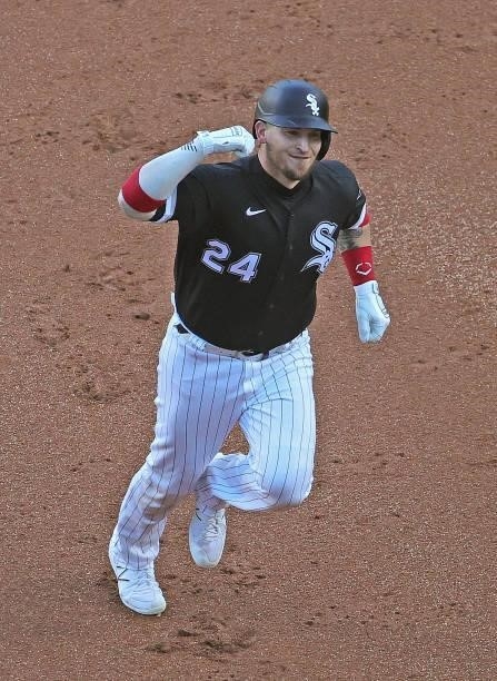 Yasmani Grandal of the Chicago White Sox smiles and pumps his fist as he runs the bases after hitting a two run home run in the 1st inning against...