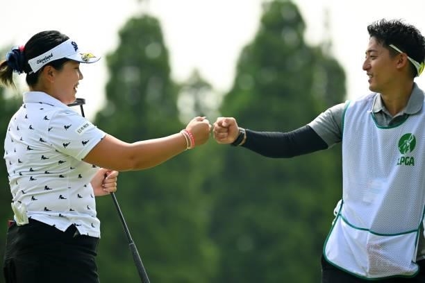 Shoko Sasaki of Japan fist bumps with her caddie after the birdie on the 13th green during the second round of the Ai Miyazato Suntory Ladies Open at...