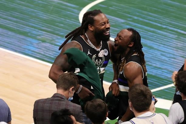 Za'Darius Smith and Aaron Jones of the Green Bay Packers celebrate a Milwaukee Bucks victory over the Brooklyn Nets in Game Three of the Eastern...