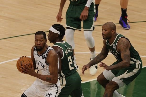 Kevin Durant of the Brooklyn Nets is defended by Jrue Holiday of the Milwaukee Bucks during the second half of Game Three of the Eastern Conference...