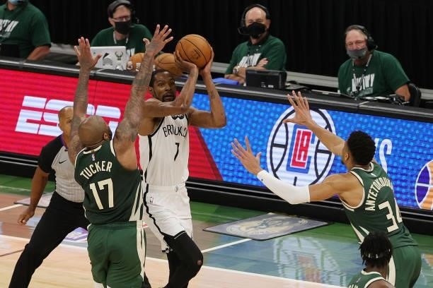 Kevin Durant of the Brooklyn Nets takes a three point shot over P.J. Tucker of the Milwaukee Bucks during the second half of Game Three of the...
