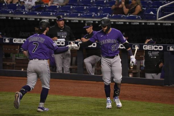 Brendan Rodgers of the Colorado Rockies celebrates with Trevor Story after hitting a home run in the seventh inning against the Miami Marlins at...