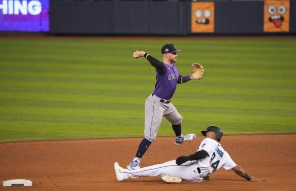 Trevor Story of the Colorado Rockies fields the ball and makes the throw to first base in the eighth inning against the Miami Marlins at loanDepot...