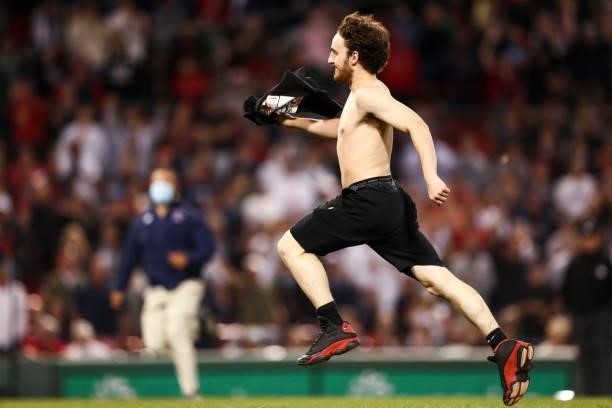 Streaker runs onto the field in the sixth inning of a game against the Houston Astros at Fenway Park on June 10, 2021 in Boston, Massachusetts.
